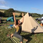 woman doing yoga in a campsite