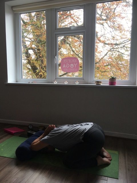 Yoga pose under a window