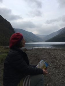 Sharon Cox-Button in front of cloudy sky and mountain lake