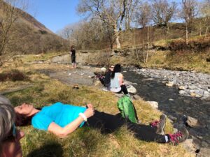 walkers relax by stream