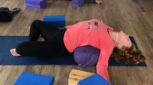 woman doing restorative yoga pose